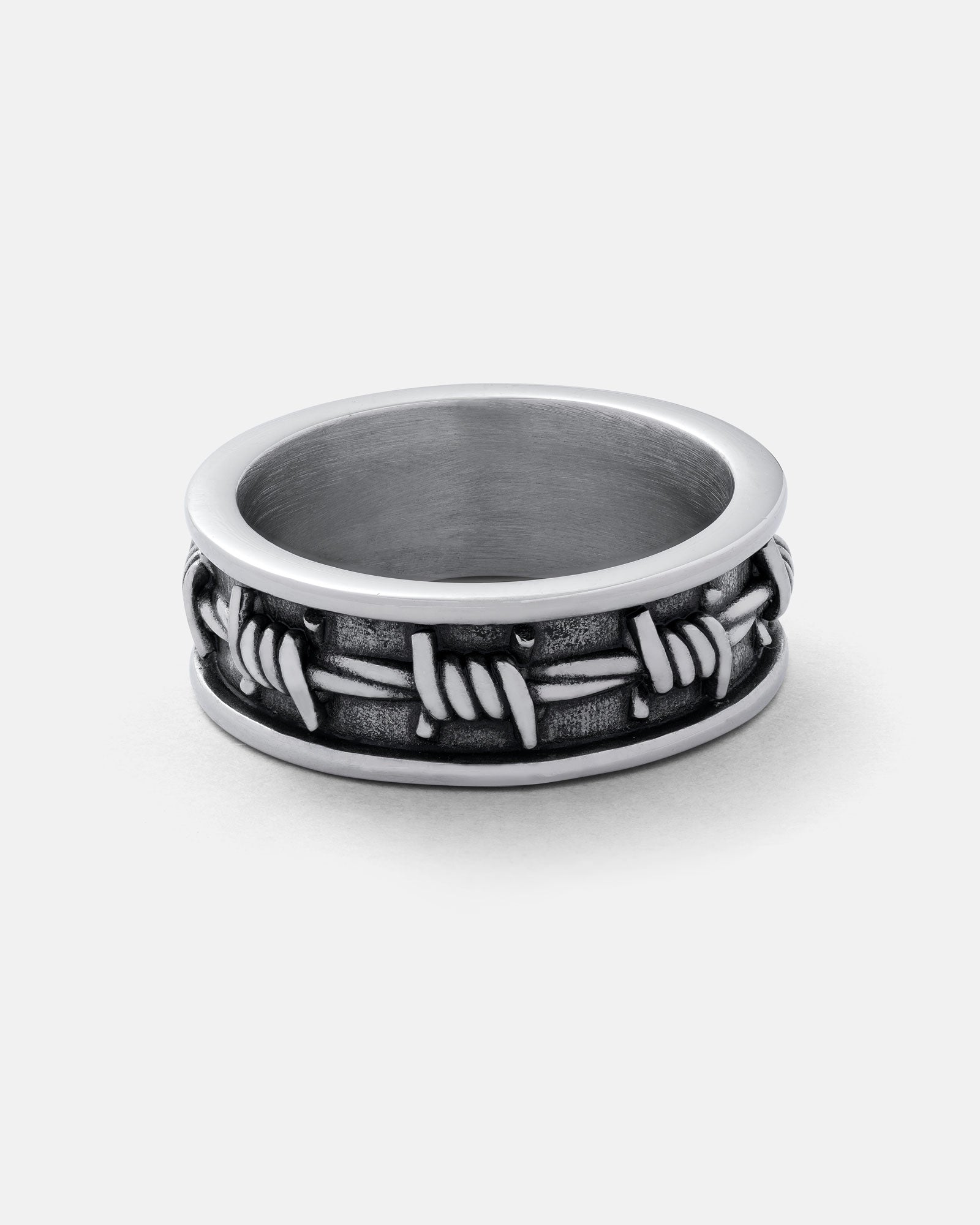 The Barbed Wire Ring features a raised barbed wire design with an oxidized silver finish for a rugged, textured look—ideal as a stackable band ring shown against a plain white background.