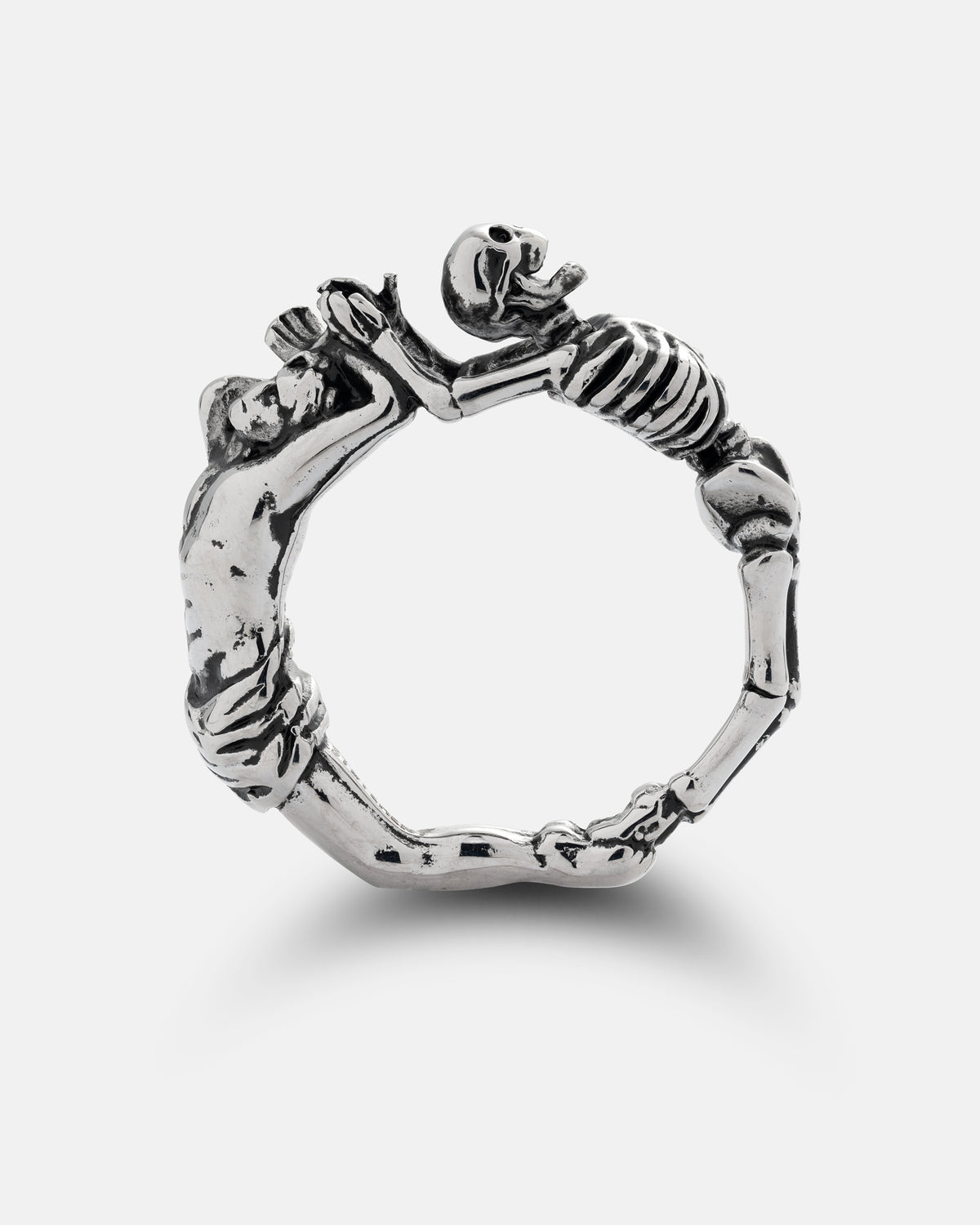 A silver Breaking Wheel Ring shaped like a skeleton grasping the outstretched arms of a person.