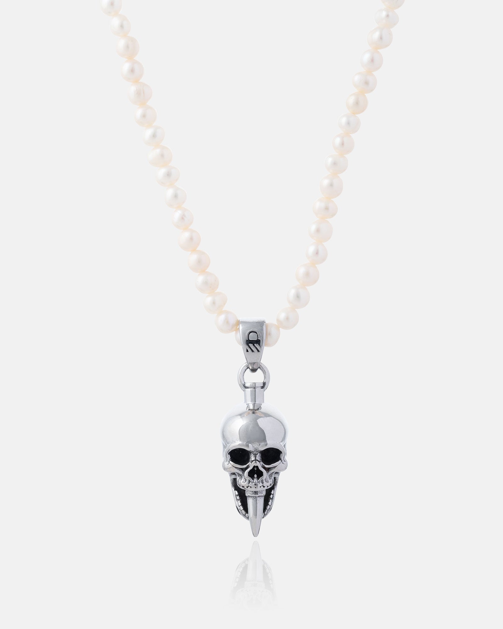 The Freshwater Pearl Necklace With Custom Pendant Choice features white, waterproof pearls and a silver skull pendant with black details and elongated fangs, shown against a plain white background.