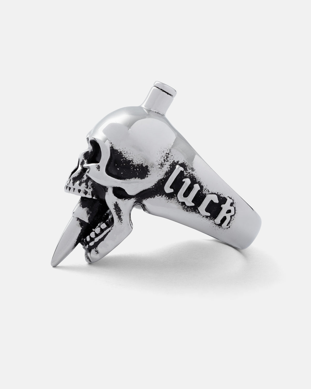 Bite The Bullet stainless steel ring shaped like a human skull with a bullet casing protruding from its mouth and the word luck engraved on the side.