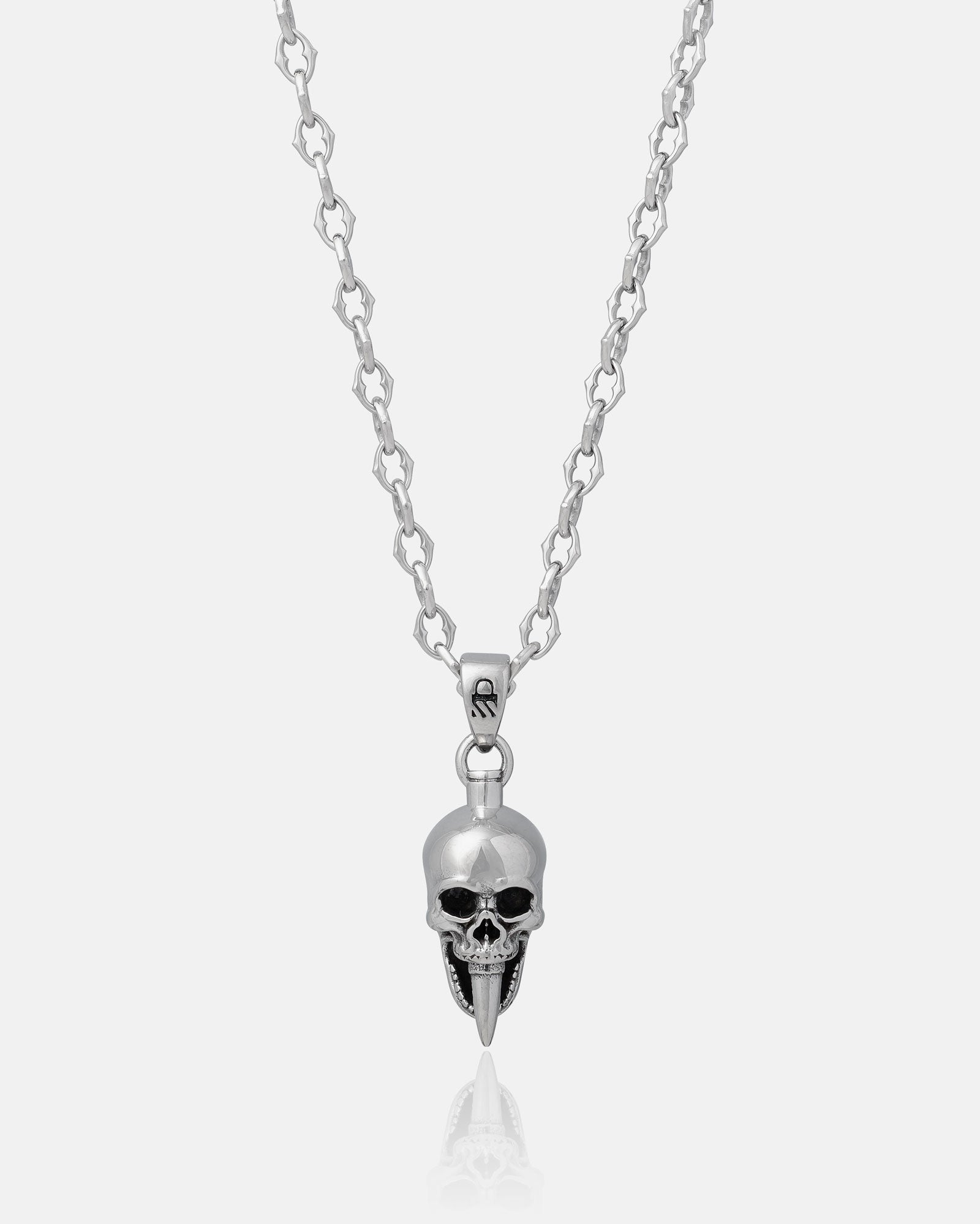 The Cathedral" 6mm silver spiked chain necklace, shown on a white background, features a stainless steel pendant with a metallic skull design—dark eye sockets and elongated fangs. Custom pendant options available.