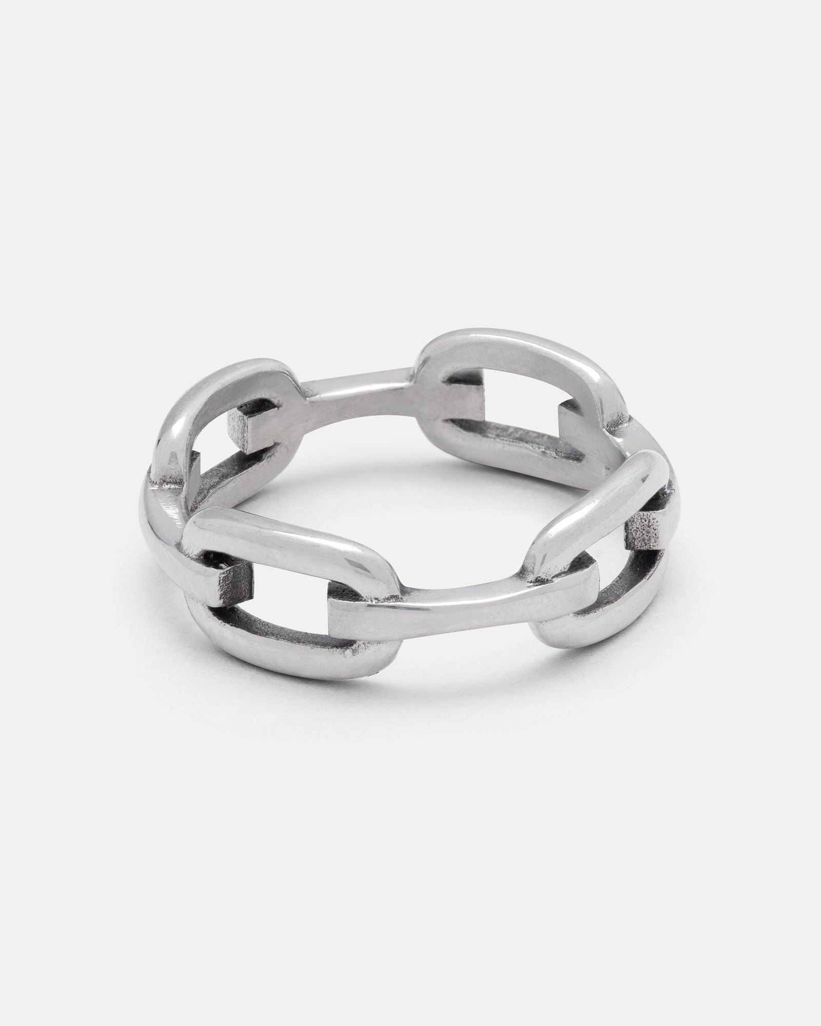 The Chained Ring by Statement Collective features a silver chain link design, creating the look of interconnected links. This minimal ring style is perfect for wearing solo or stacking with other bands, and is showcased here against a plain white background.
