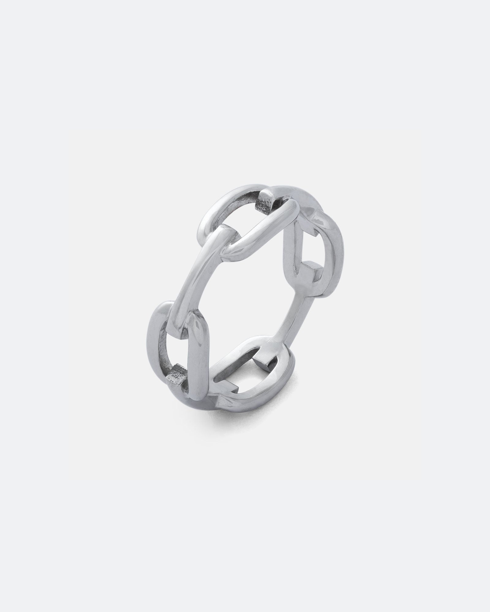 The Chained Ring is a silver chain link ring with interlocking links, ideal for wearing solo or stacked. Displayed against a light gray background.
