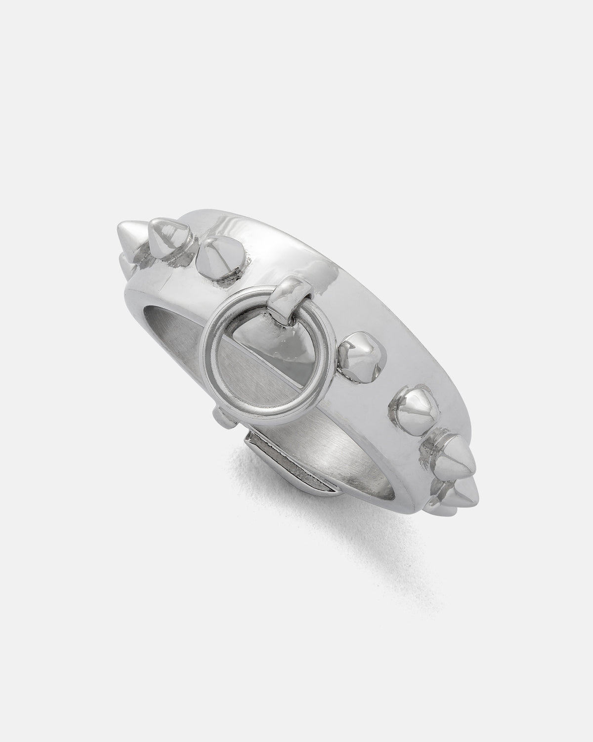 The Statement Collective Spiked Dog Collar Ring is a silver goth ring adorned with evenly spaced conical studs around the band and finished with a circular loop detail on the front, reminiscent of a spiked dog collar, shown against a plain white background.