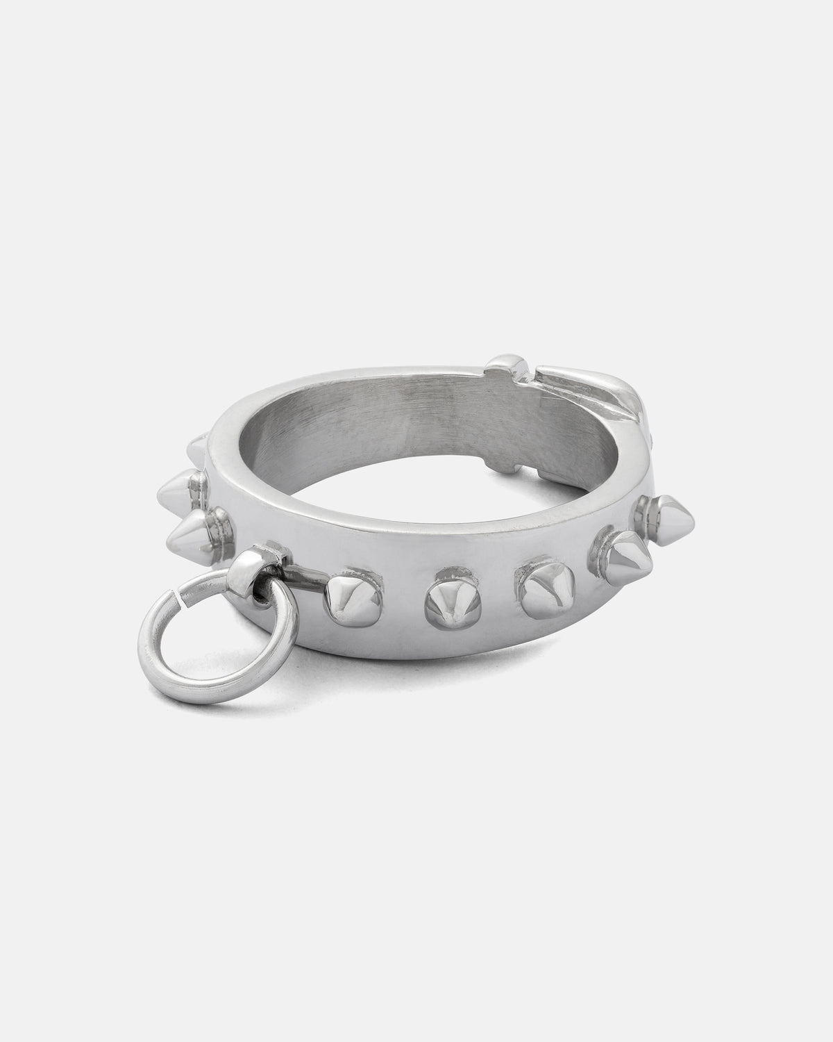 The Statement Collective Spiked Dog Collar Ring features a silver metal bracelet adorned with evenly spaced spikes and a small stainless steel ring on one side, reminiscent of a goth ring, shown against a plain white background.