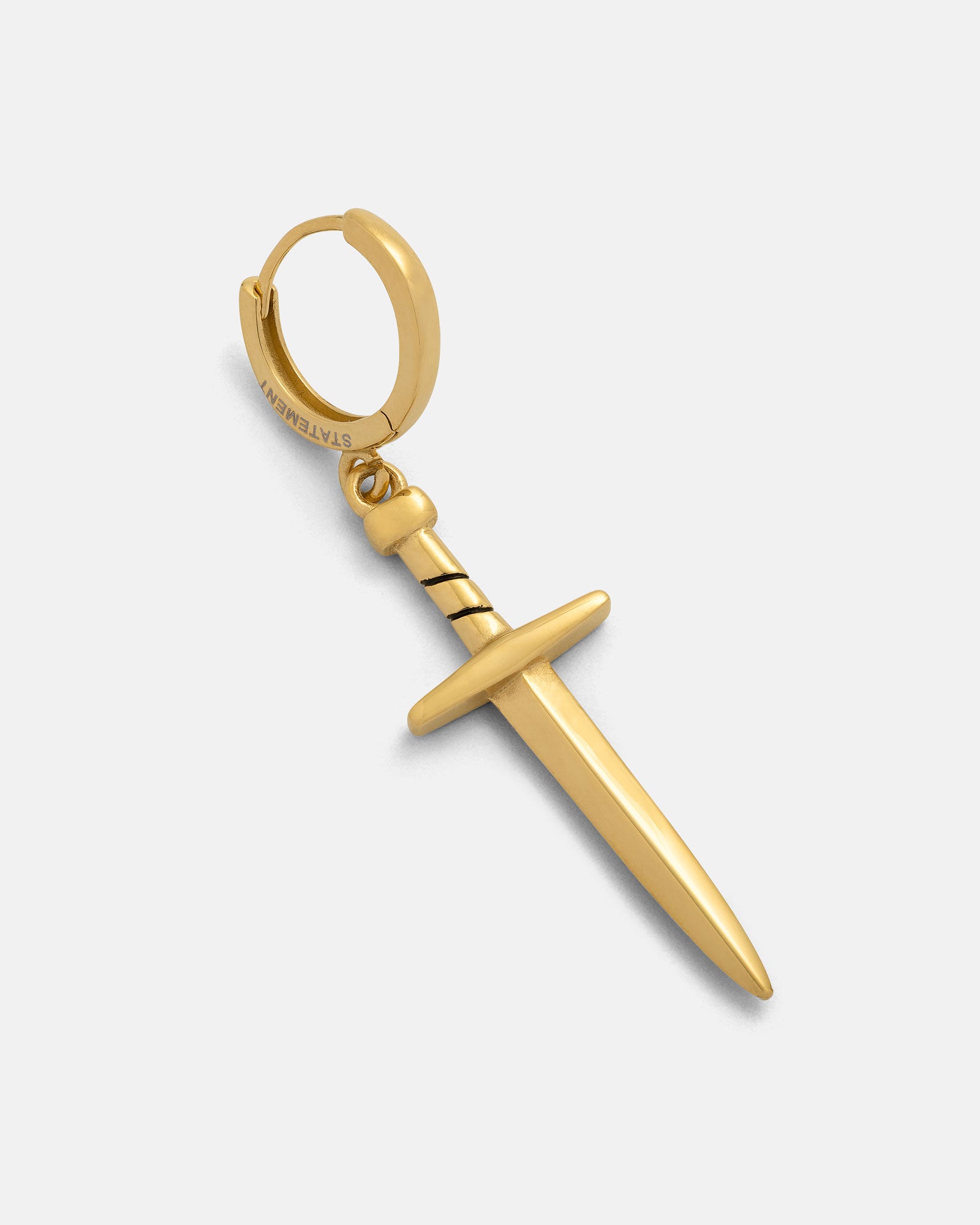 The Dagger Earring (Gold) features a hoop with a dangling sword-shaped charm and a black accent near the handle, shown against a plain light background.