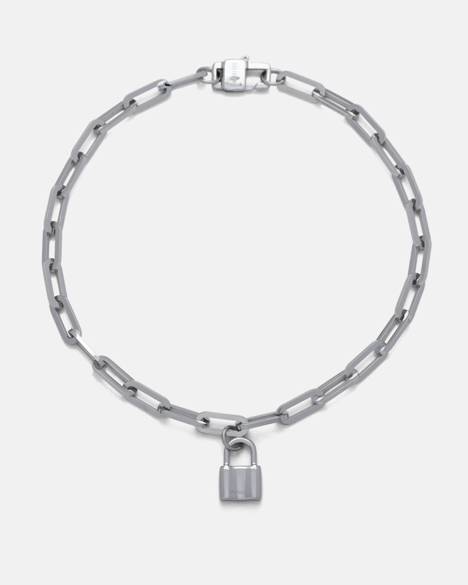 The Dainty Charm Choker (Custom Pendant Choice) features a silver paperclip chain with elongated links and a small silver padlock pendant at the center, shown on a plain white background.