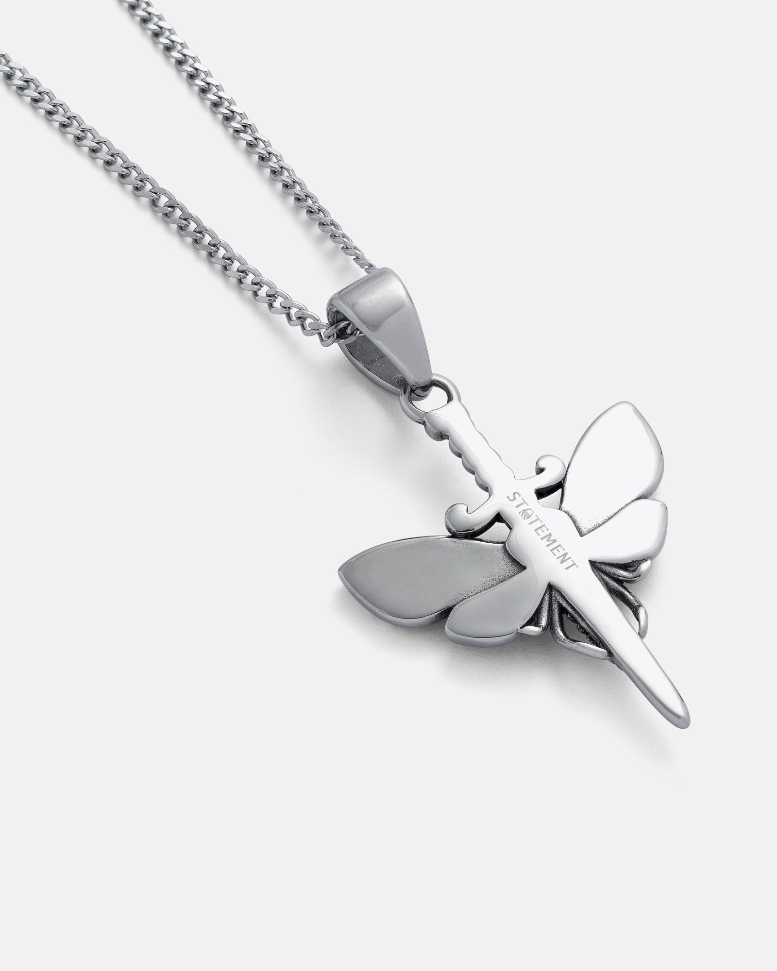 Death's Head Moth Pendant: A silver necklace inspired by Silence of the Lambs, featuring a dragonfly-shaped pendant with a sword body. "STRENGTH" is engraved on the stainless steel pendant, hung on a silver chain against a white background.