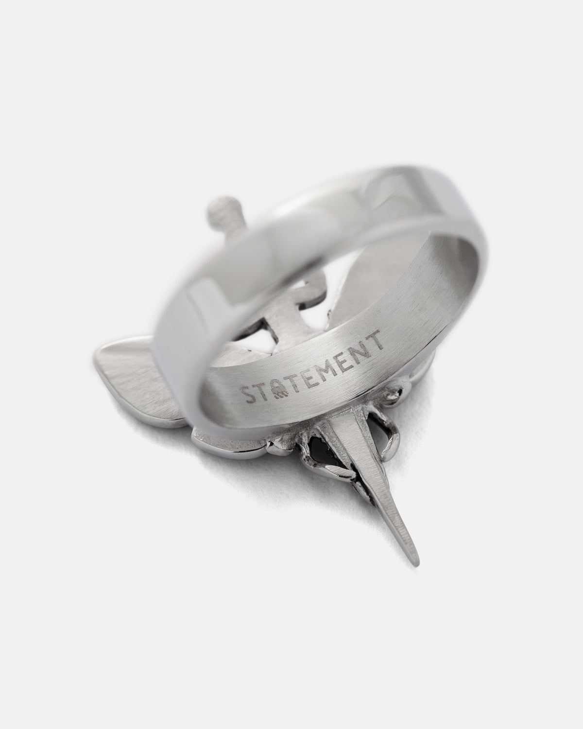 Silver Death’s Head Moth Ring by Statement Collective featuring the word STATEMENT engraved on the inner band.