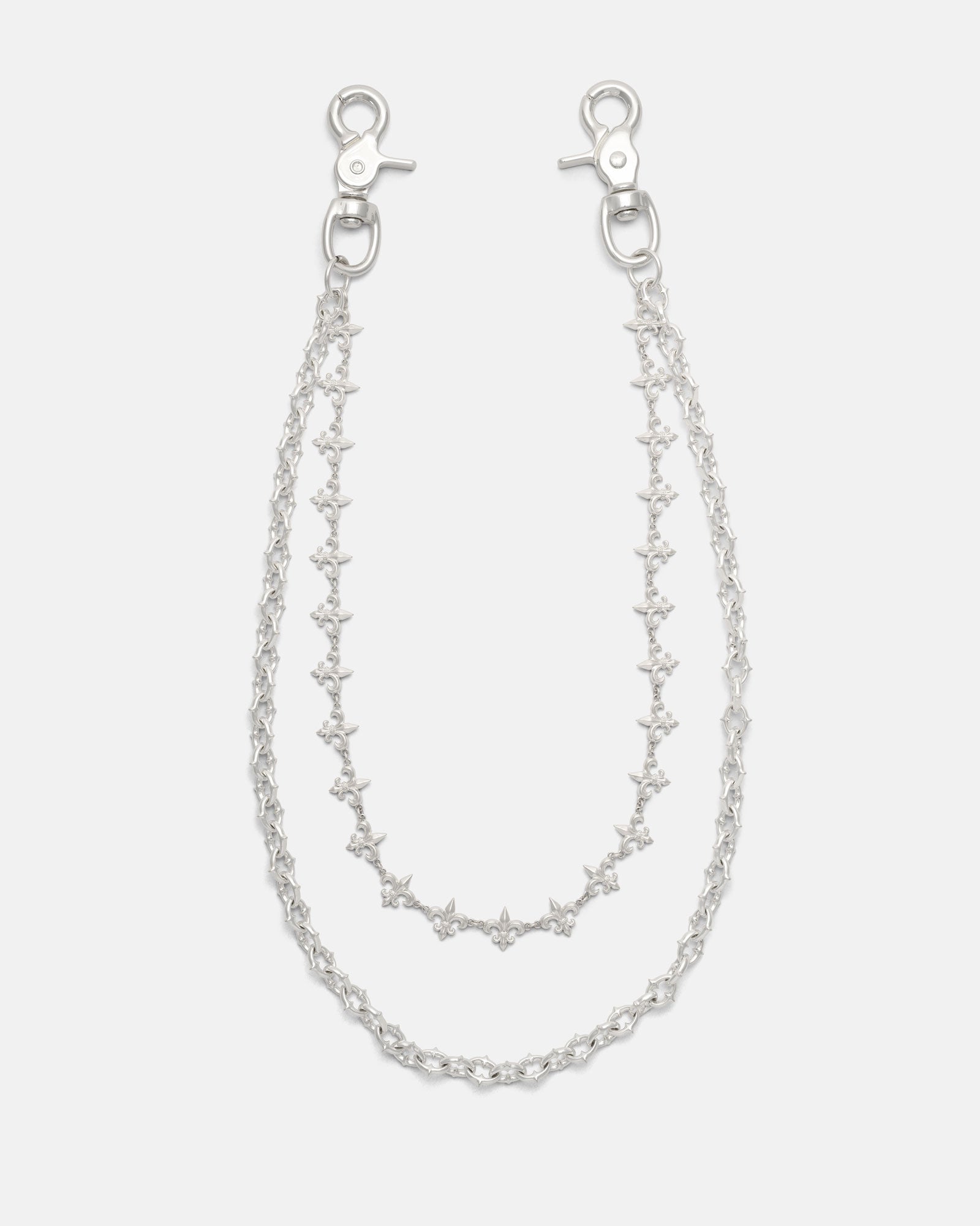 Introducing the “Baroque” Fleur De Lis Wallet Chain by Statement Collective: this set features two sterling silver chains, each fitted with clasp hooks at both ends and designed with star-shaped links accented by delicate fleur de lis motifs. The chains come in slightly different lengths to create a layered effect, beautifully displayed against a plain white background.
