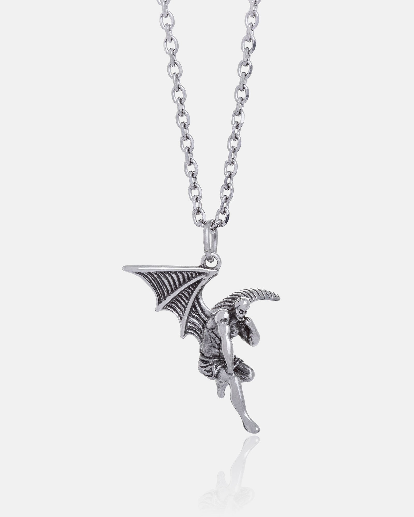 The Fallen Angel Pendant is a silver necklace featuring a winged demon in a crouched pose with detailed wings. Its medium-length chain with rounded links adds unique style to gothic jewellery designs.