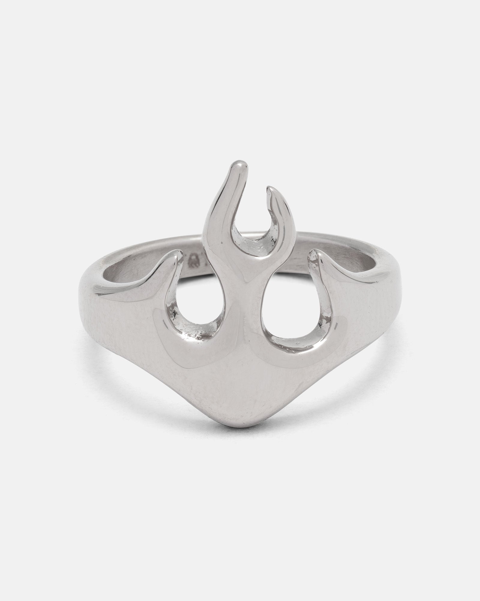 The Statement Collective Flame Ring is a silver stainless steel accessory showcasing a striking flame-shaped design at its center, set against a plain white background. This bold streetwear ring is also hypoallergenic, ensuring comfortable wear every day.