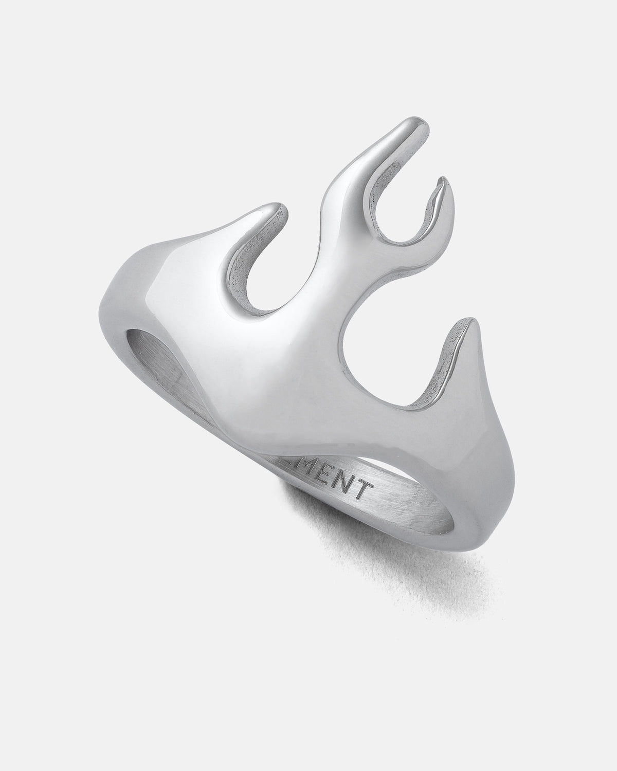 The Statement Collective Flame Ring is a silver stainless steel accessory that showcases an abstract, flame-inspired design with smooth, flowing curves, making it the perfect bold addition to any streetwear look. Photographed against a plain white background.