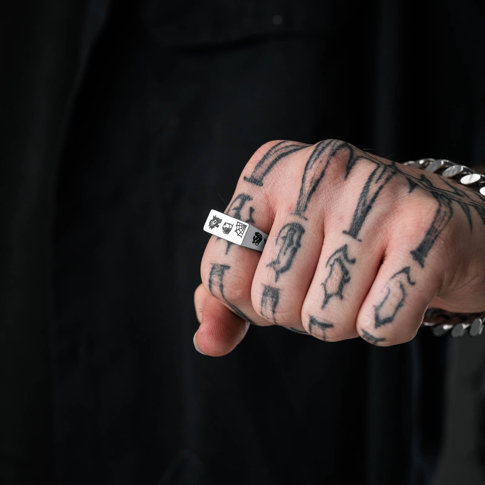 flash tattoo signet ring on mens hand by statement