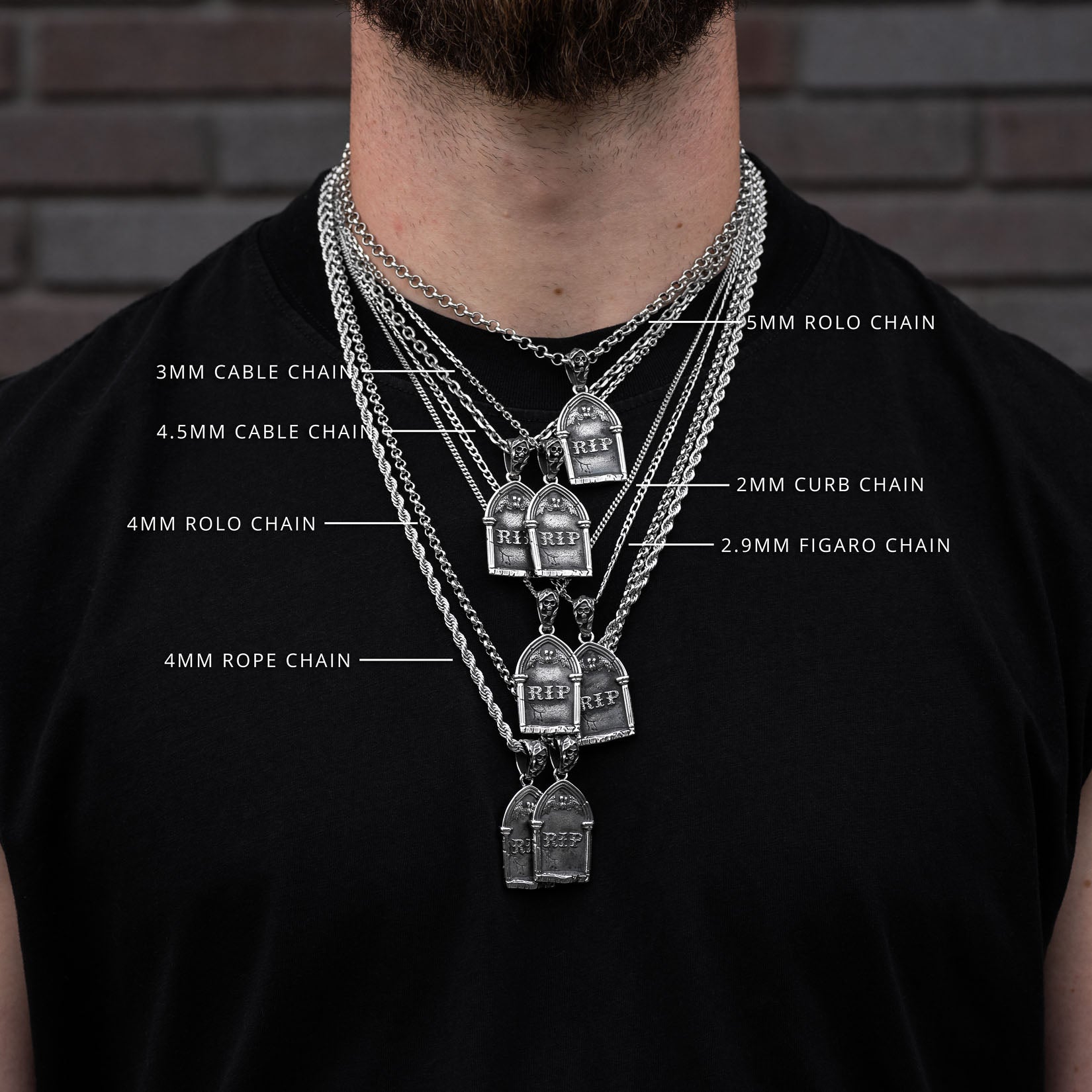 Man wearing multiple tombstone necklaces with chain types labeled against a brick wall background