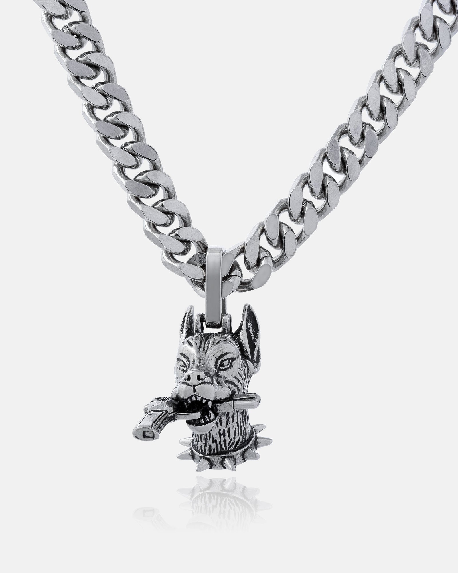 The Guard Dog" Pendant is a silver chain necklace with a detailed fierce dog head holding a bone, featuring pointed ears and intricate fur—ideal for hip hop jewelry fans wanting bold style.