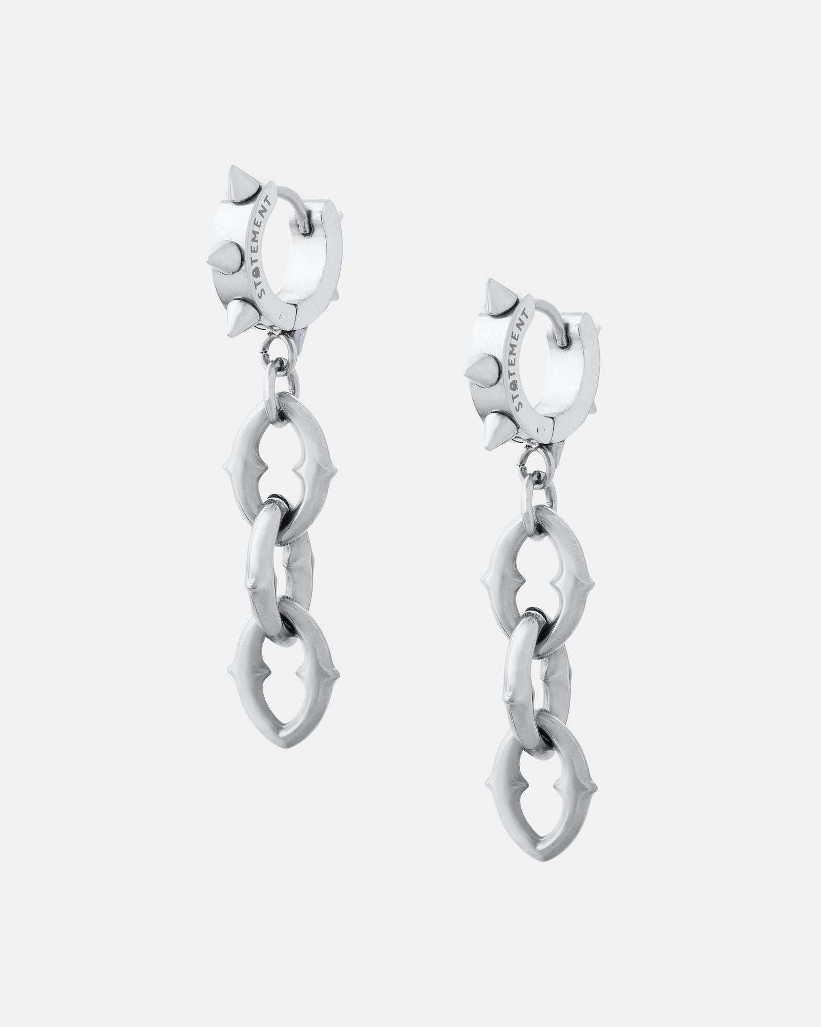 The Cathedral" 9mm Chain Earrings feature circular studs with two interlocking spiked rings dangling from each. Made of polished stainless steel, these modern silver hoops offer an edgy, contemporary look.
