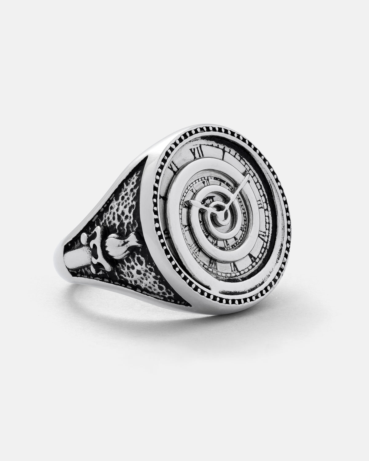 Introducing the Infinite Clock Ring by Statement Collective: a silver ring showcasing an intricately engraved spiral clock face with Roman numerals, complemented by detailed band patterns and a distinctive bird motif on the side.