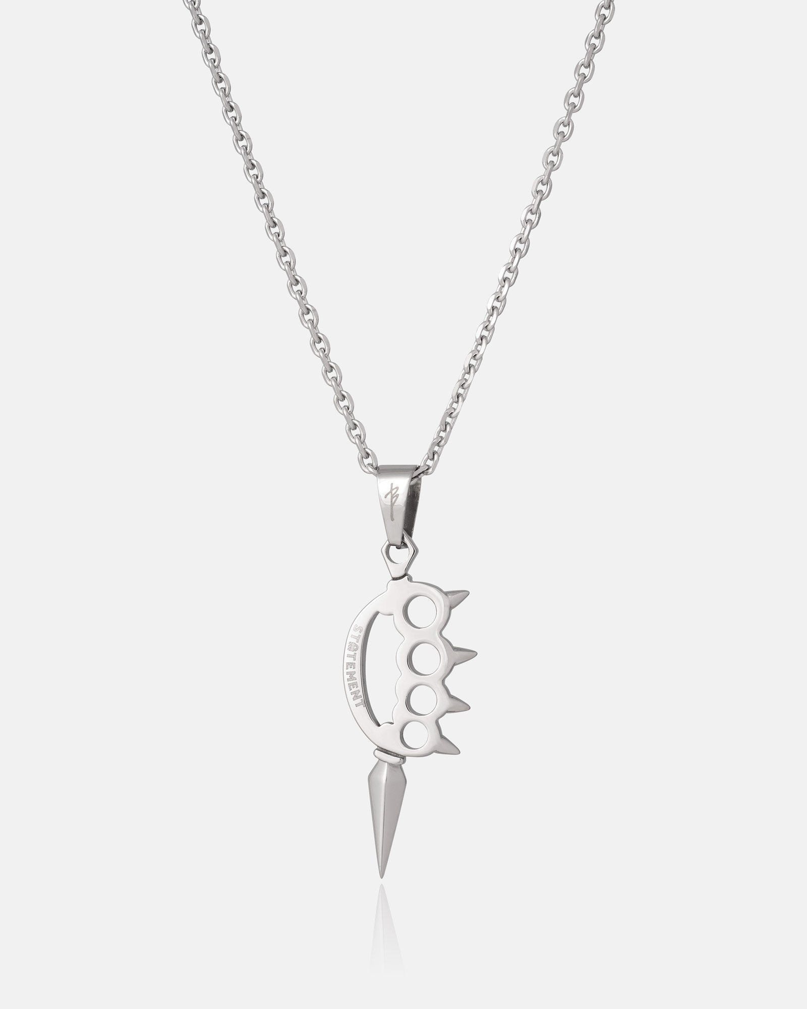 Silver necklace with a knuckle duster design hanging on a white background