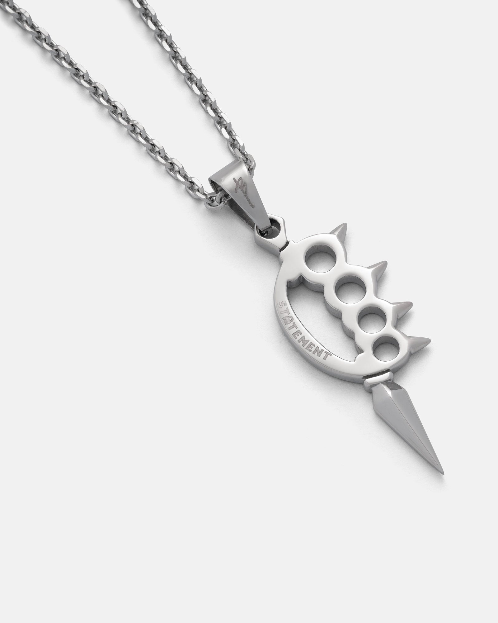 Silver knuckle duster necklace with a sharp end on a white background