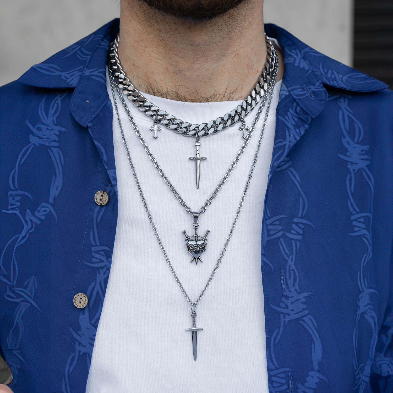 Sword pendant necklace set on mans neck by Statement Collective