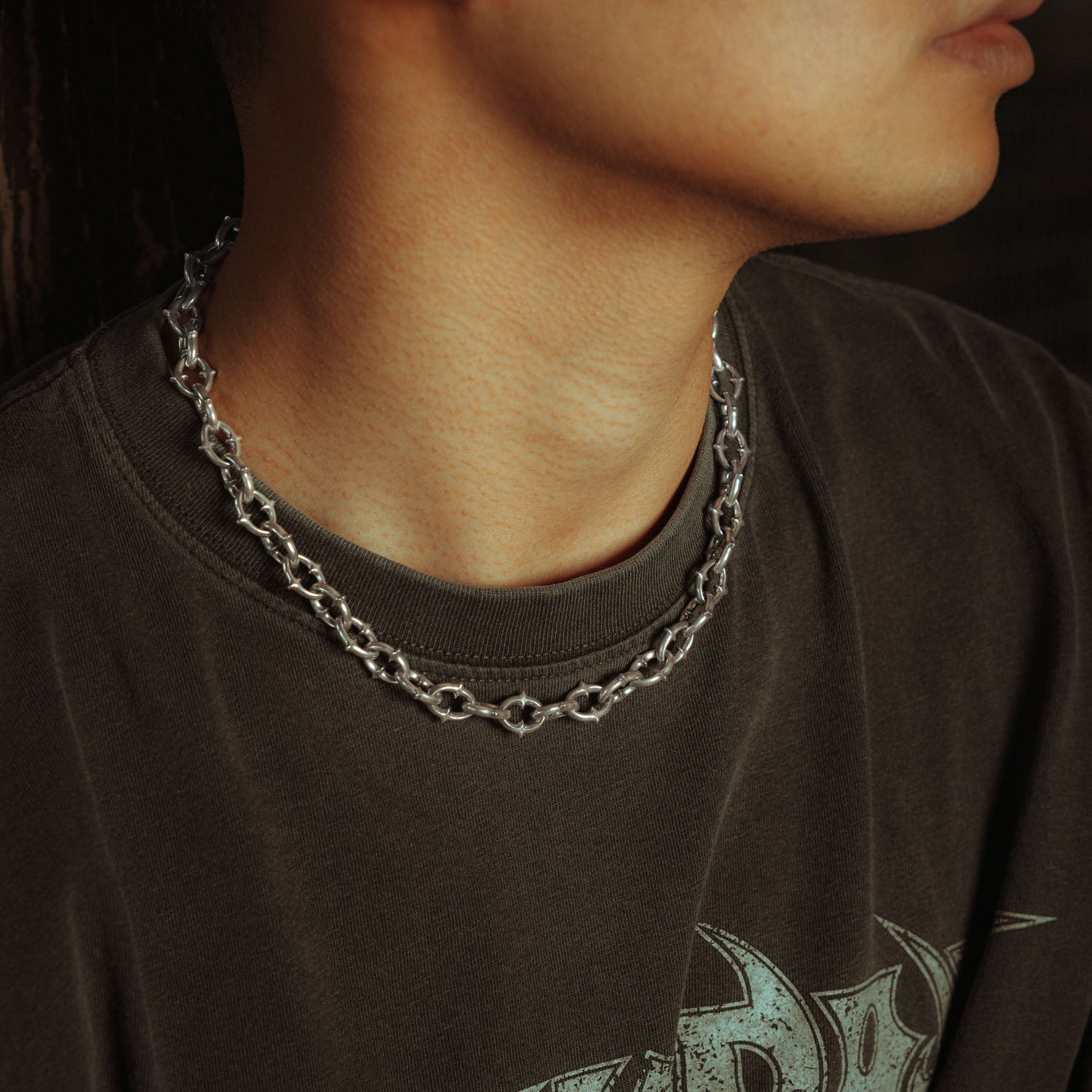 9mm spiked chain in sterling silver on male model with grey shirt