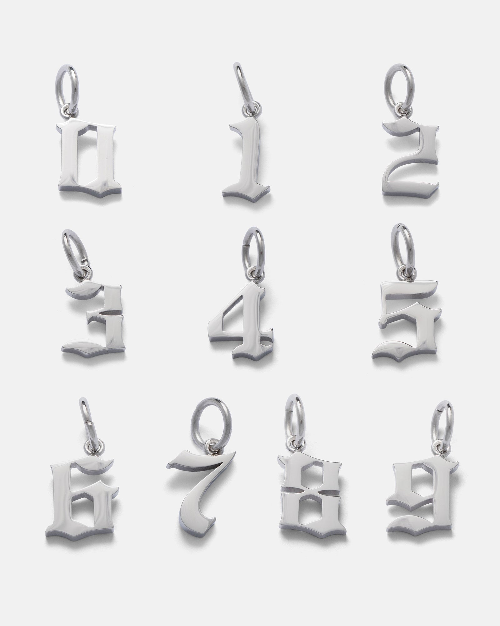 Nine silver gothic-style number pendants (0–9) from Statement Collective’s Statement Piece Customisable Necklace are arranged in three rows on a white background—perfect for creating your own personalised necklace.