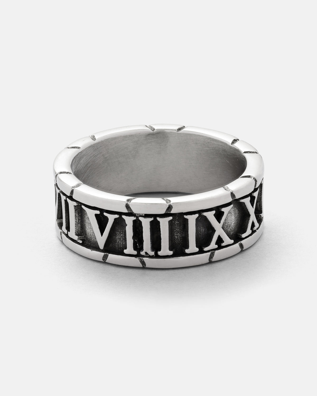 Discover the Numerals Ring by Statement Collective—a striking silver band adorned with engraved Roman numerals from VII to XII. Its slightly oxidized background highlights the polished rim, making it an ideal choice for stacking or wearing as a standout statement piece.