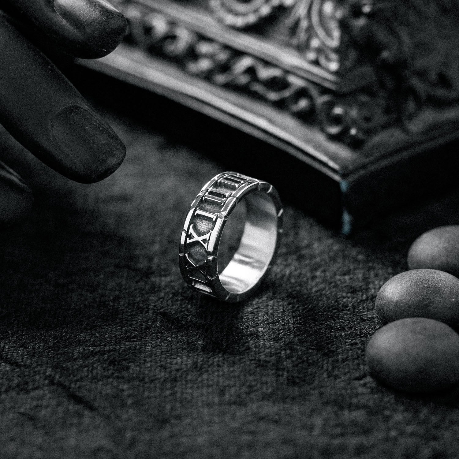 cracked roman numerals ring on black background by statement collective