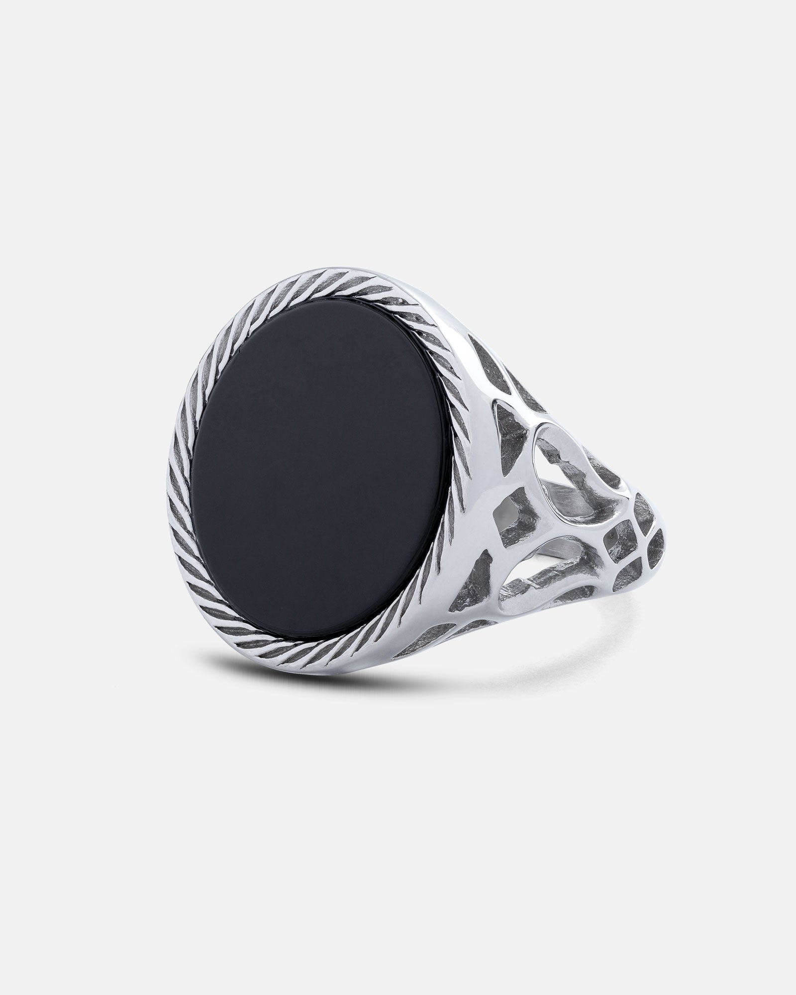 Silver signet ring with intricate lattice pattern and a black stone on a light gray background
