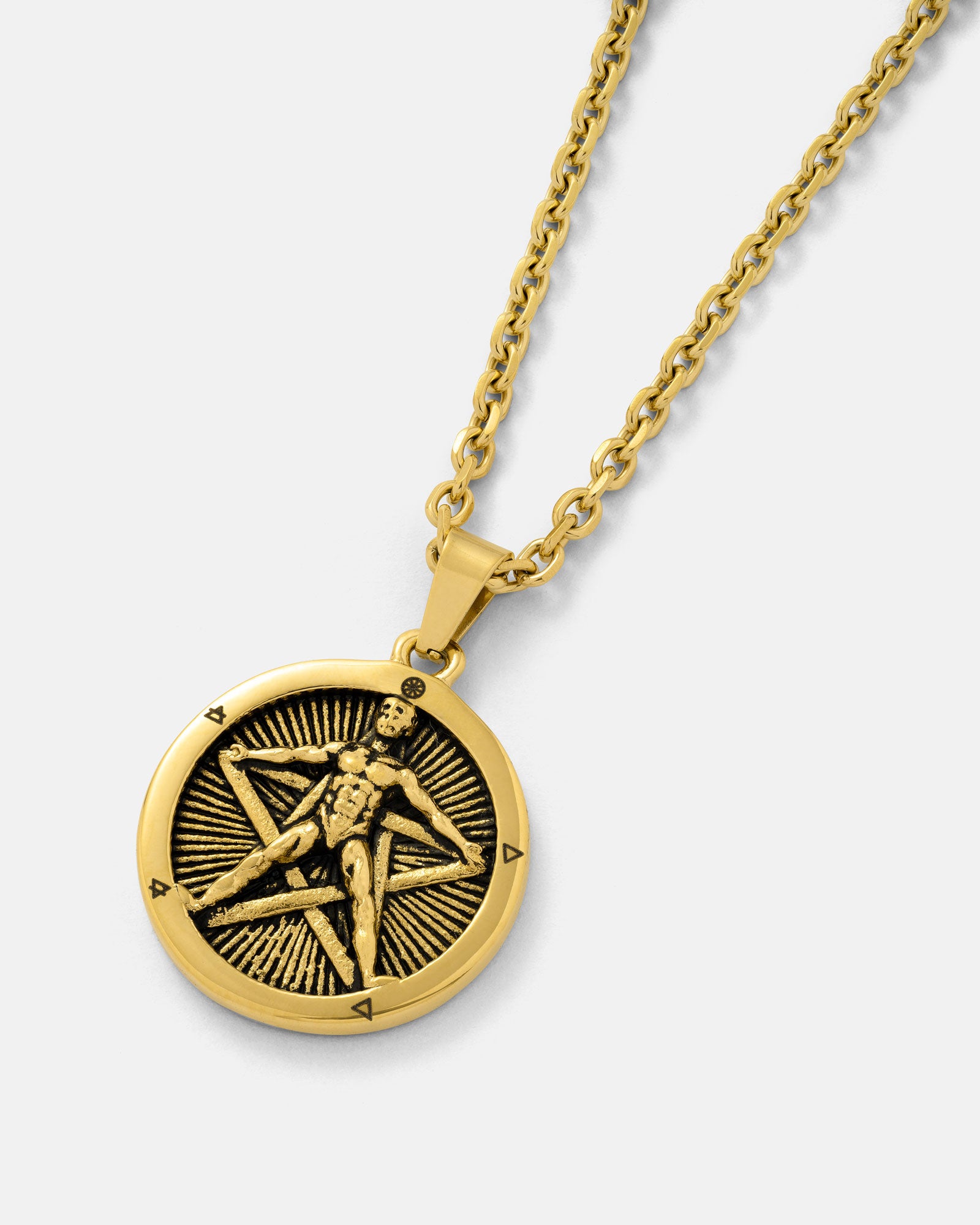 The "Star of the Magi" Pendant (Gold) is an 18K gold-plated necklace with a pentagram pendant, featuring a raised human figure over a five-pointed star, radiating lines, and small edge symbols.