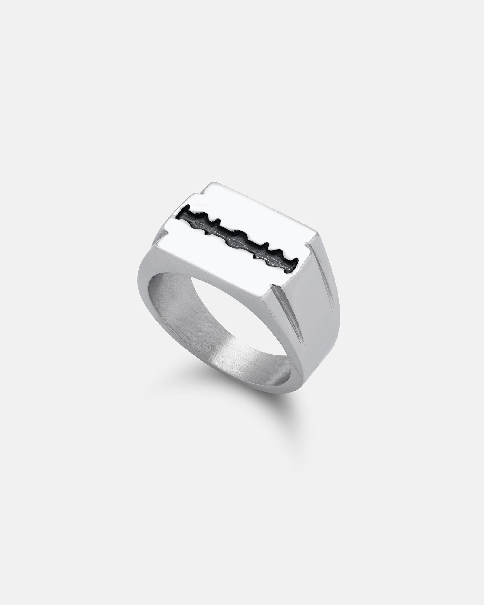 The Razor Blade Signet Ring is a bold punk jewelry piece, crafted from stainless steel with a flat rectangular top and black detailing along the blade’s edge, shown on a plain white background.