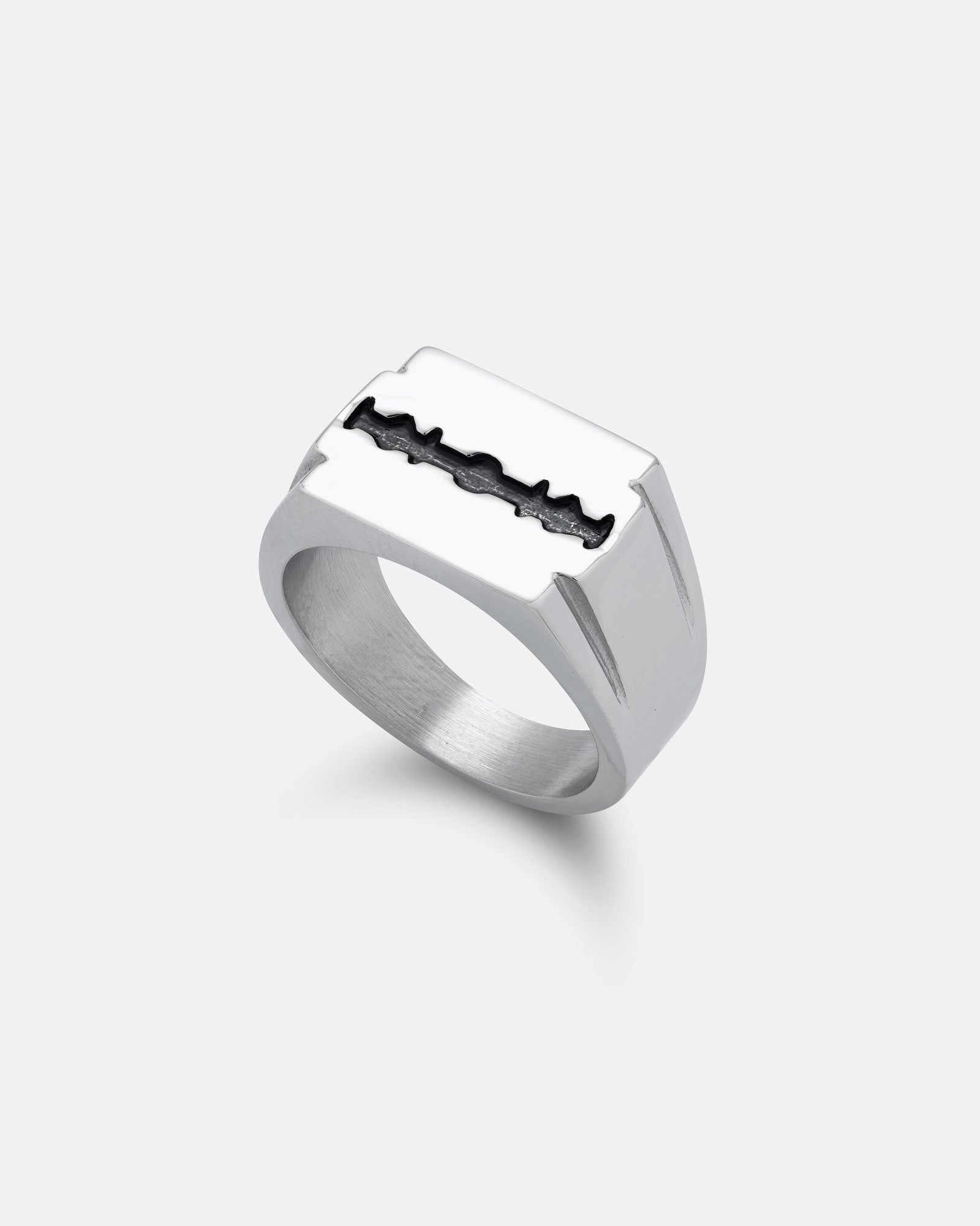 The Razor Blade Signet Ring features a flat top design with a black razor blade inset on stainless steel, shown on a white background—a bold statement piece for punk style.