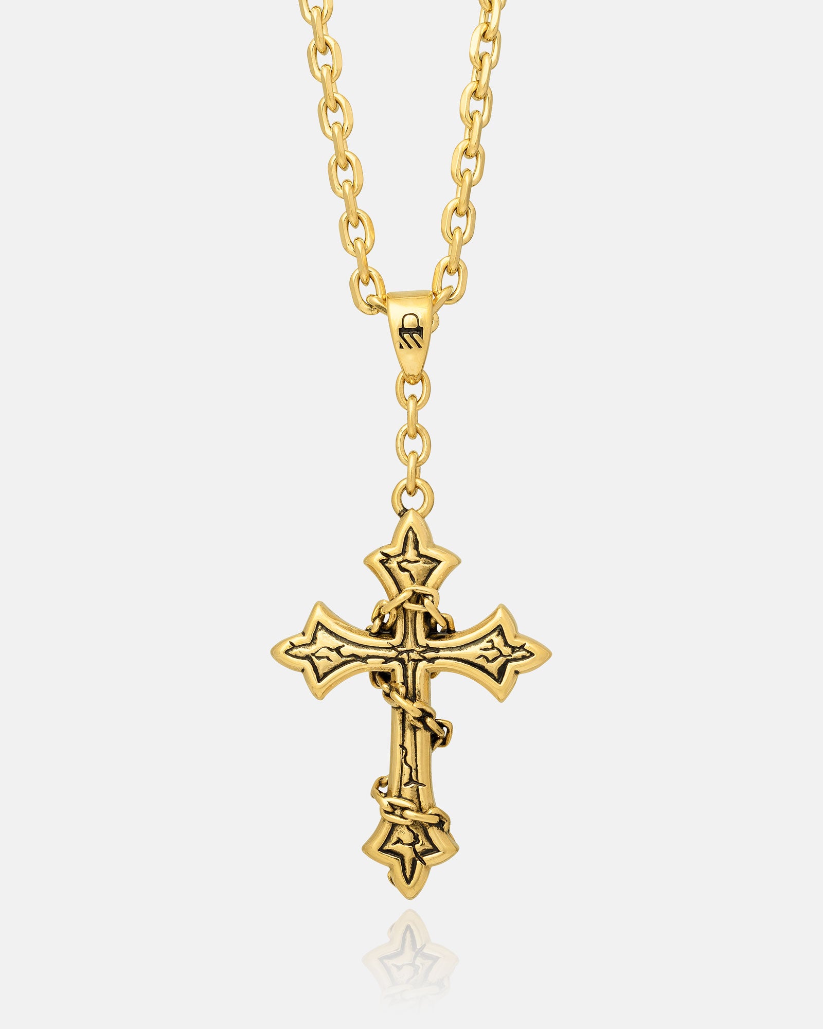 The Ruins" Pendant (Gold) is an 18k gold plated necklace featuring a striking gothic cross with pointed tips and a barbed-wire design wrapped around the center.