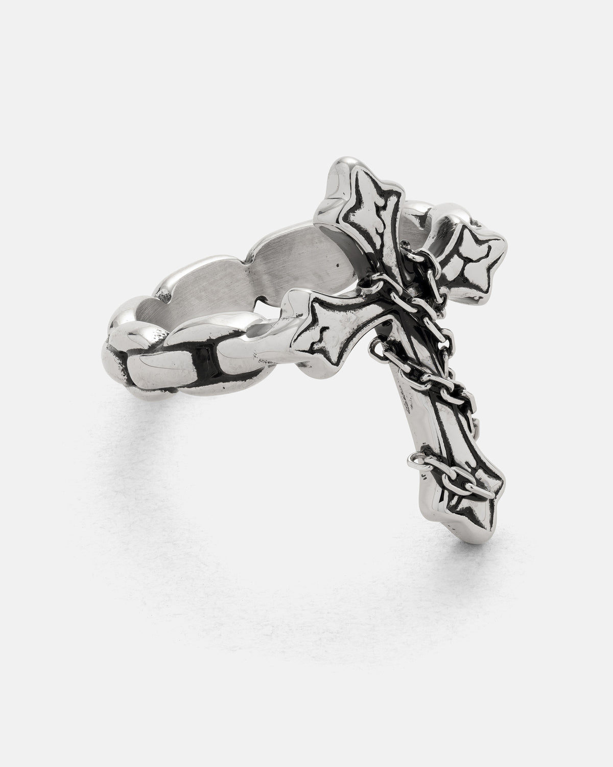 Statement Collective The Ruins Chained Cross Ring, a stainless steel ring featuring an ornate cross charm draped with a small metal chain.