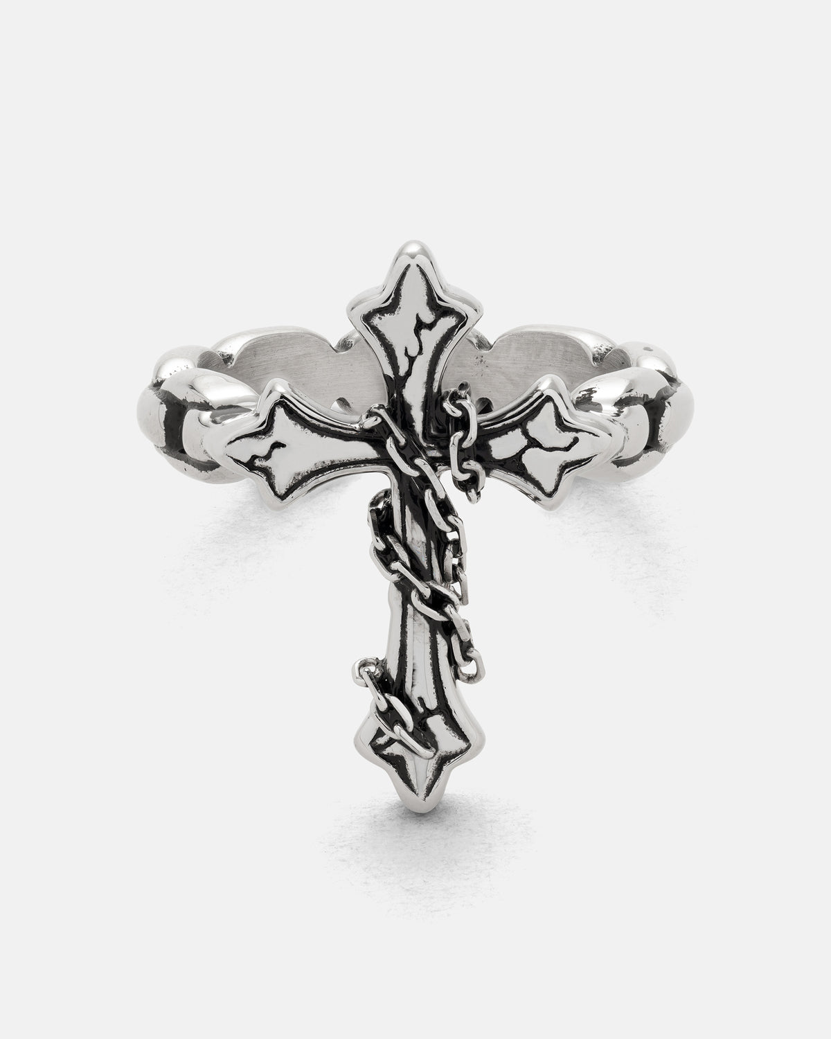 The Ruins Chained Cross Ring in silver, featuring an ornate centerpiece wrapped in a small dangling chain.
