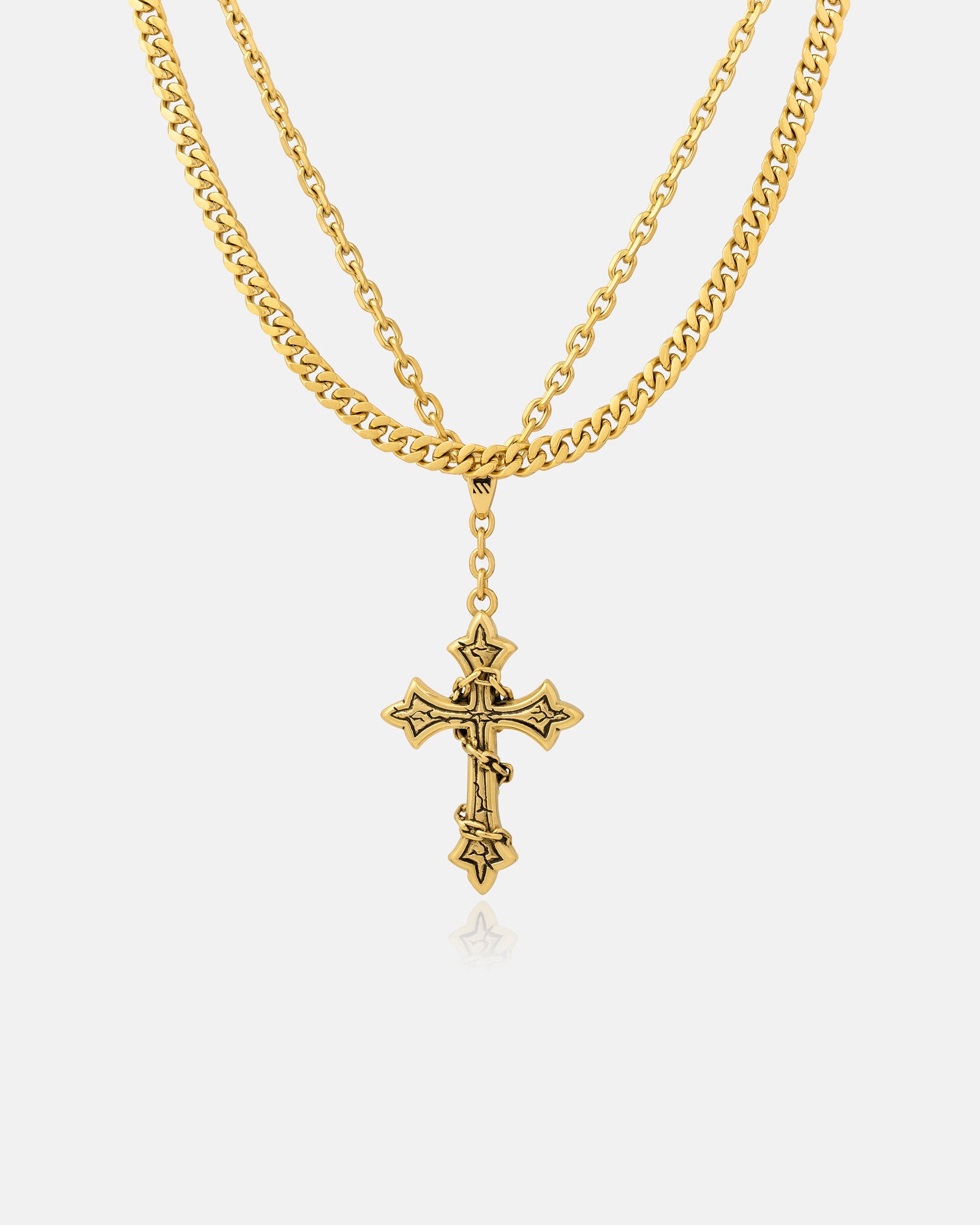 The Ruins" 6mm Set (Gold) necklace features a decorative gothic cross pendant with intricate details, elegantly displayed on a plain white background.