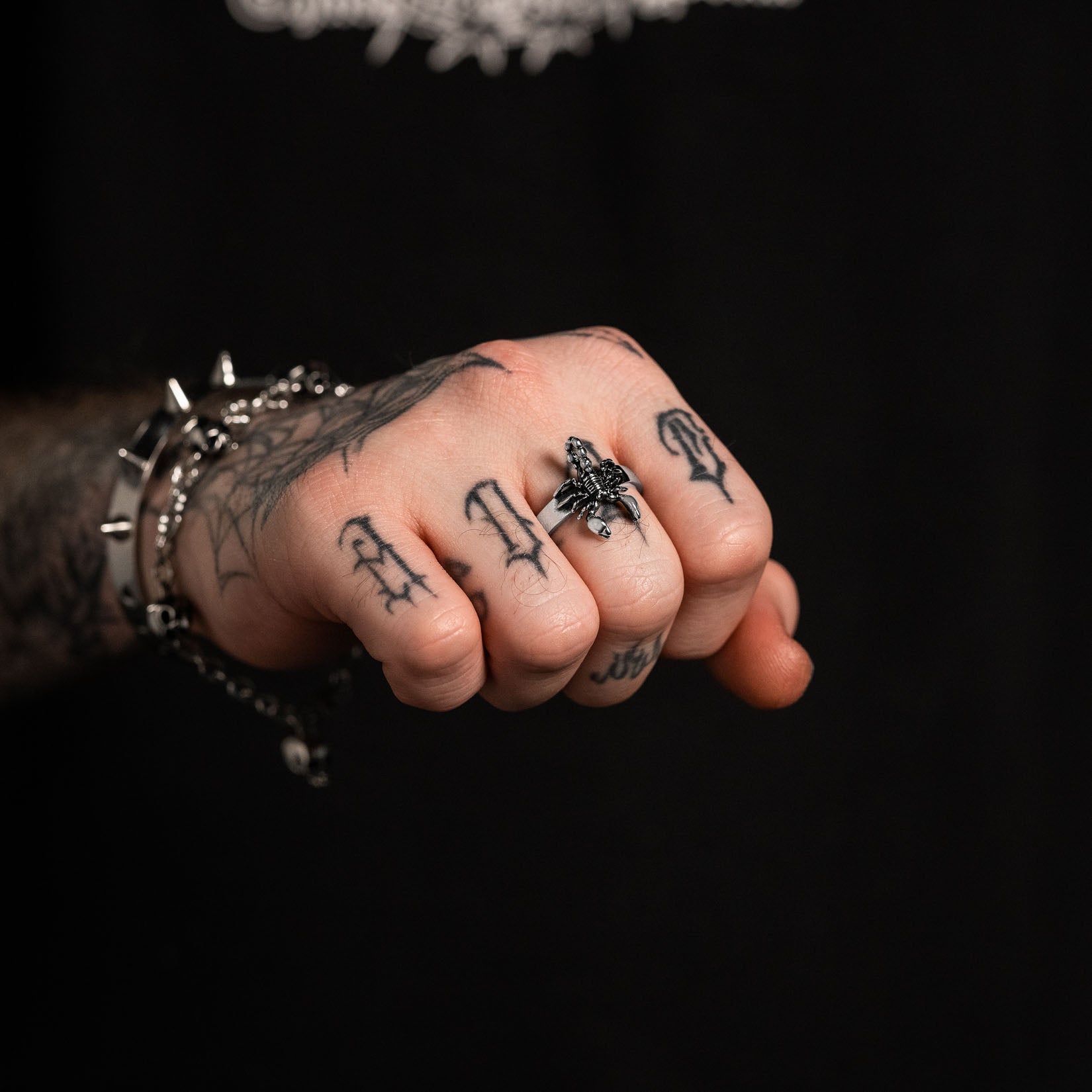mens hand wearing silver scorpion ring by statement collective