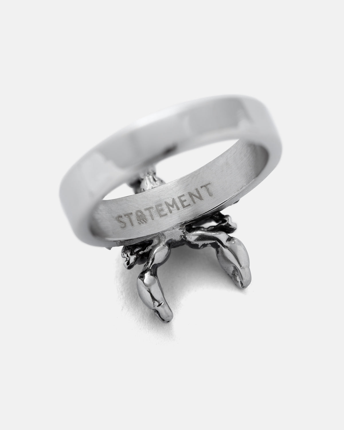 Silver Scorpion Ring with the word STATEMENT engraved on the inner band.