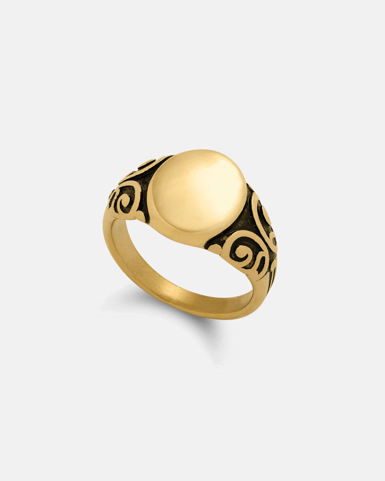 The Mini Oval Scroll Signet Ring (Gold) by Statement Collective is an elegant 18k gold ring with a smooth oval face and intricate black scrollwork on the band, shown on a plain white background.