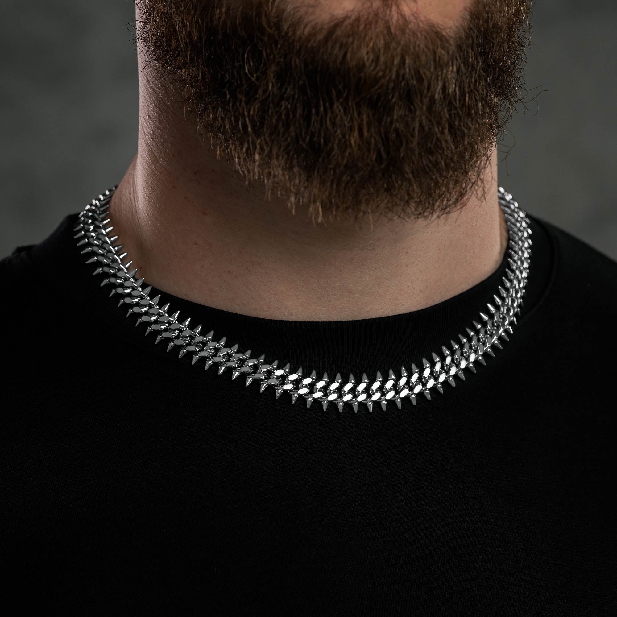 Silver 9mm Cuban chain with spikes on every link, on male model
