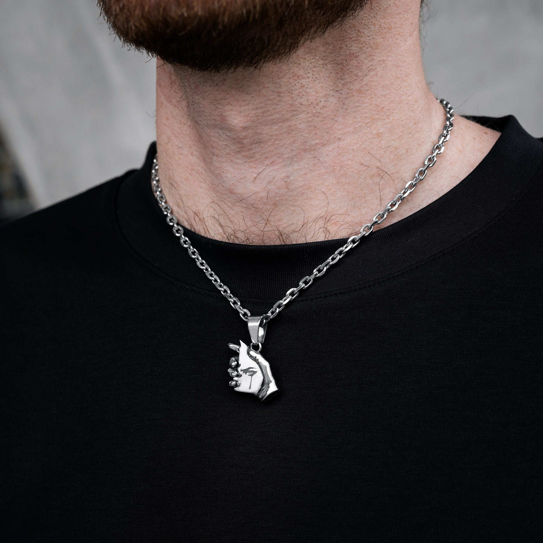 hand necklace pendant on model's neck