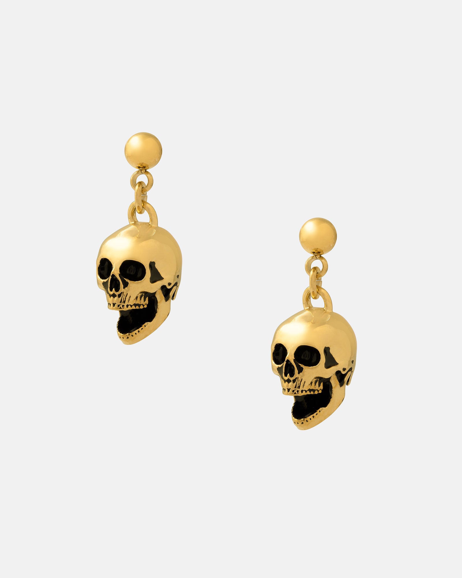 The Skull Earrings (Gold) are 18k gold-plated drop earrings with dangling skull charms, black accents, and small round studs—perfect rock punk jewelry for a bold statement.