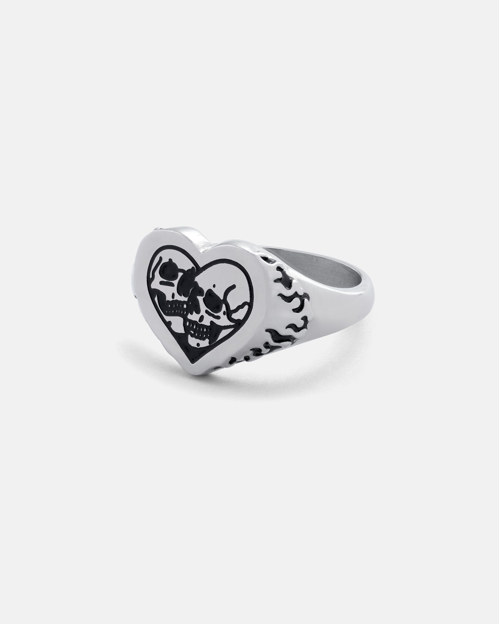 The Skull Heart Ring in silver showcases a heart-shaped face with a black skull design and black flame patterns on the sides, offering a bold, unique gothic style. The product is photographed against a plain white background.