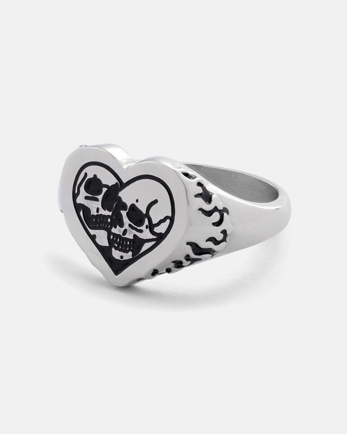 A bold piece from STATEMENT, the Skull Heart Ring is crafted from silver stainless steel and features a heart-shaped face engraved with two black skulls, complemented by intricate flame designs along the sides.