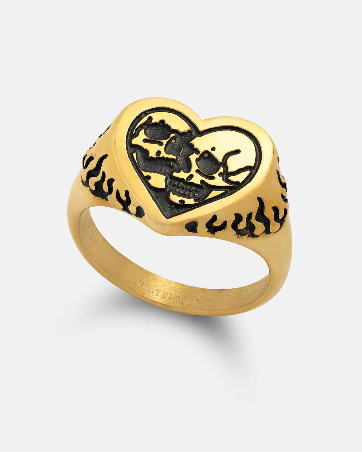The Skull Heart Ring (Gold) by Statement Collective features a heart-shaped face adorned with two black skulls kissing, encircled by a flame pattern etched along the band and sides. Crafted in 18k gold plated metal, this bold piece makes a striking addition to any gothic jewellery collection.