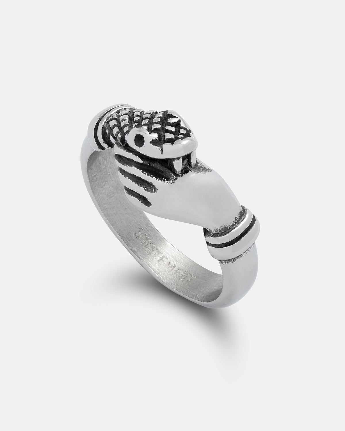 Presenting “The Hand That Bites” Ring by Statement Collective—a silver piece designed as two hands gripping each other, with one hand adorned in a textured snakeskin-patterned glove.