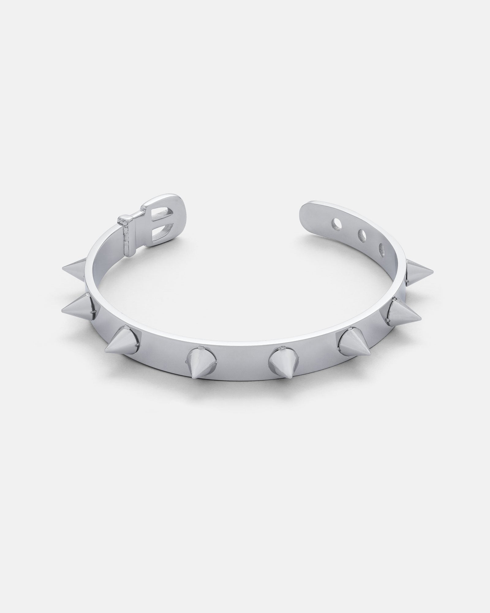 Silver Spiked cuff bracelet in the style of a dog collar by statement collective on grey background
