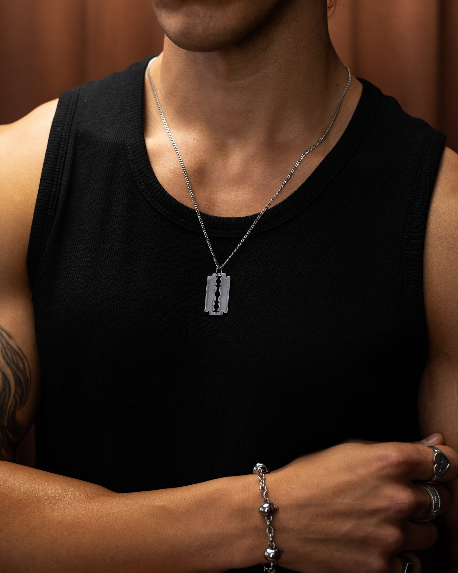 Stainless Steel razorblade pendant necklace on model by statement collective