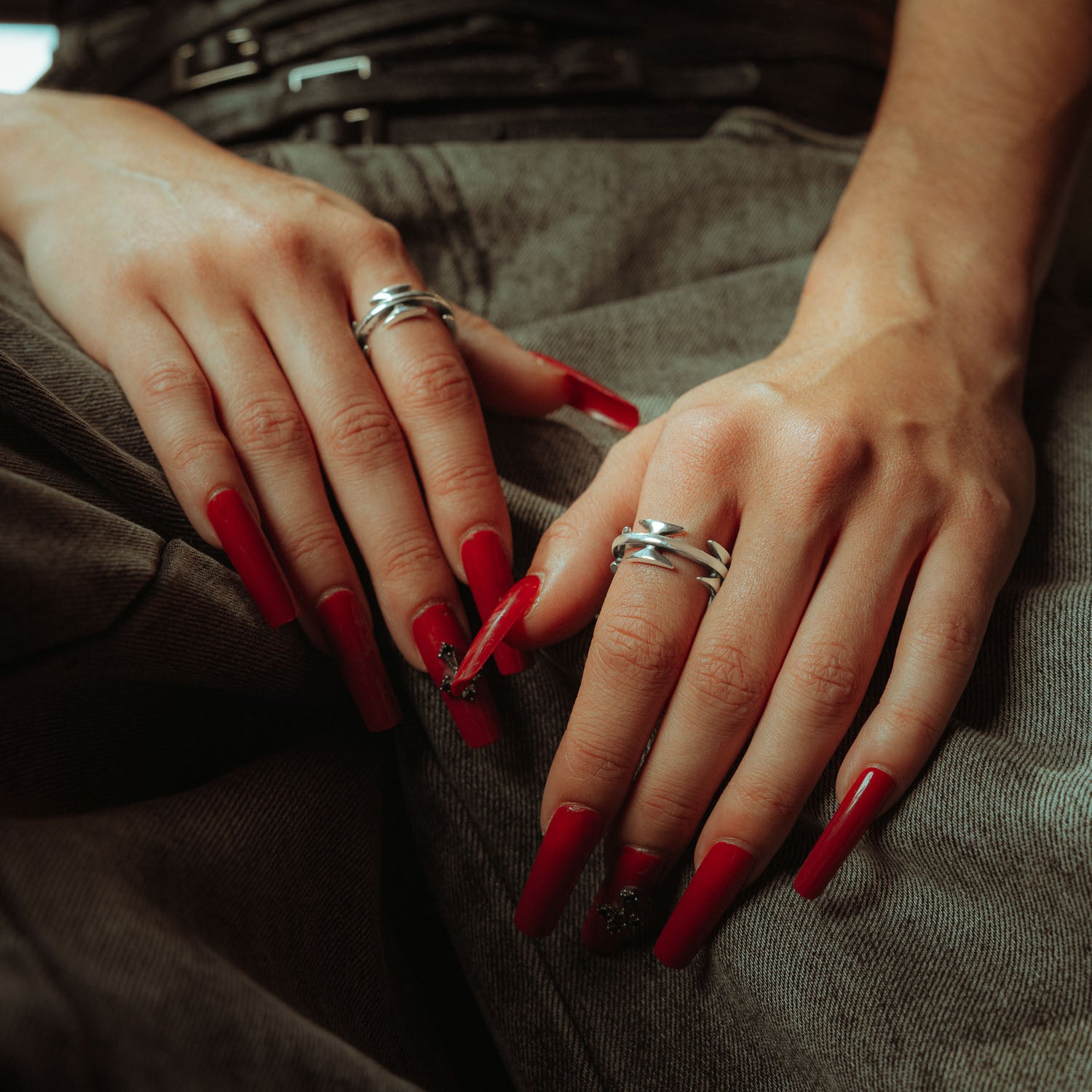sterling silver razor wire ring on female model with red nails